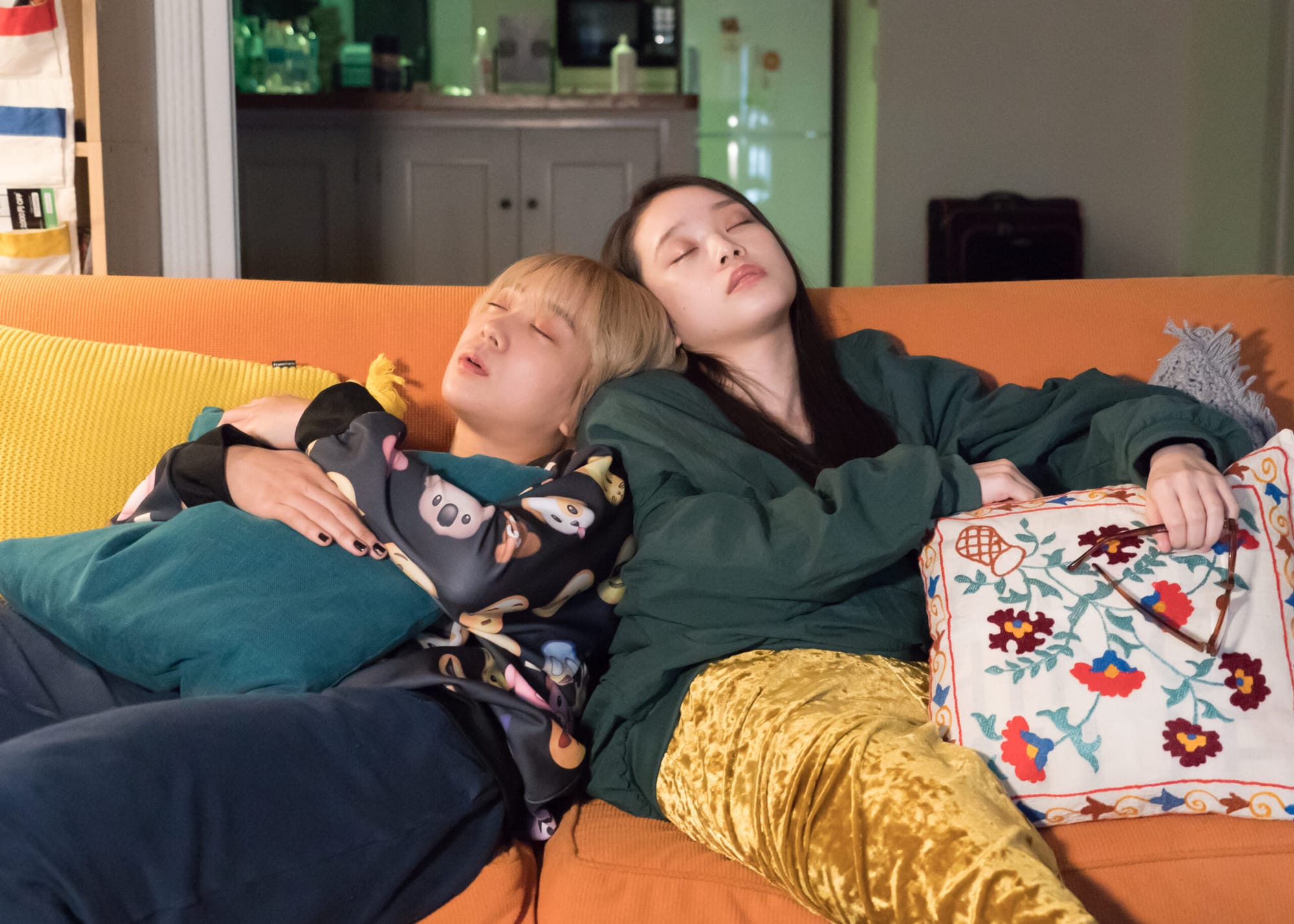 Mahiro and Chisato asleep on the couch in Baby Assassins