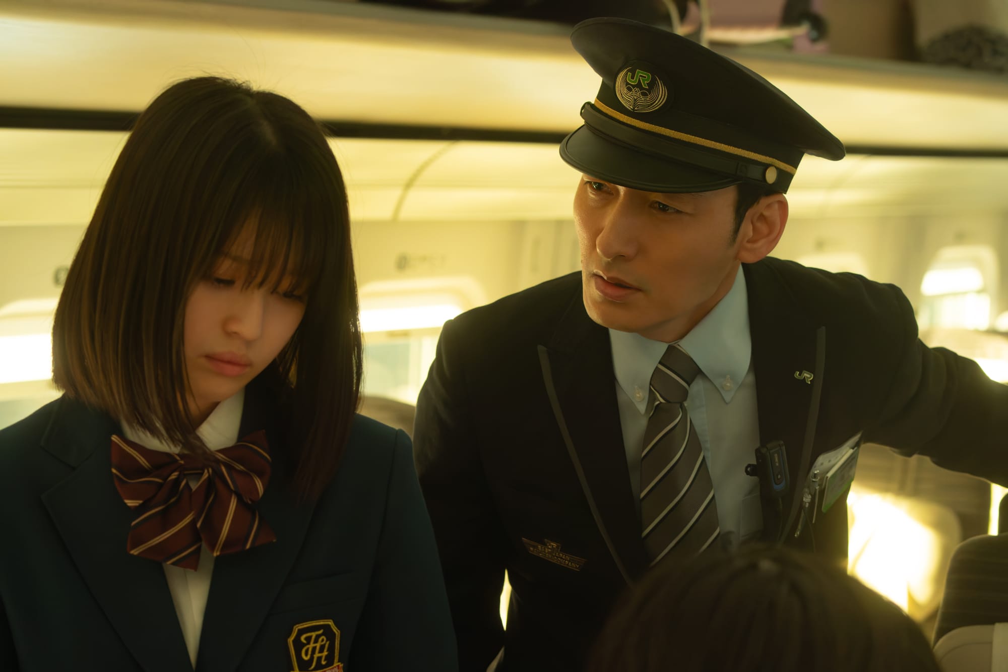 The conductor speaks with a passenger in Bullet Train Explosion