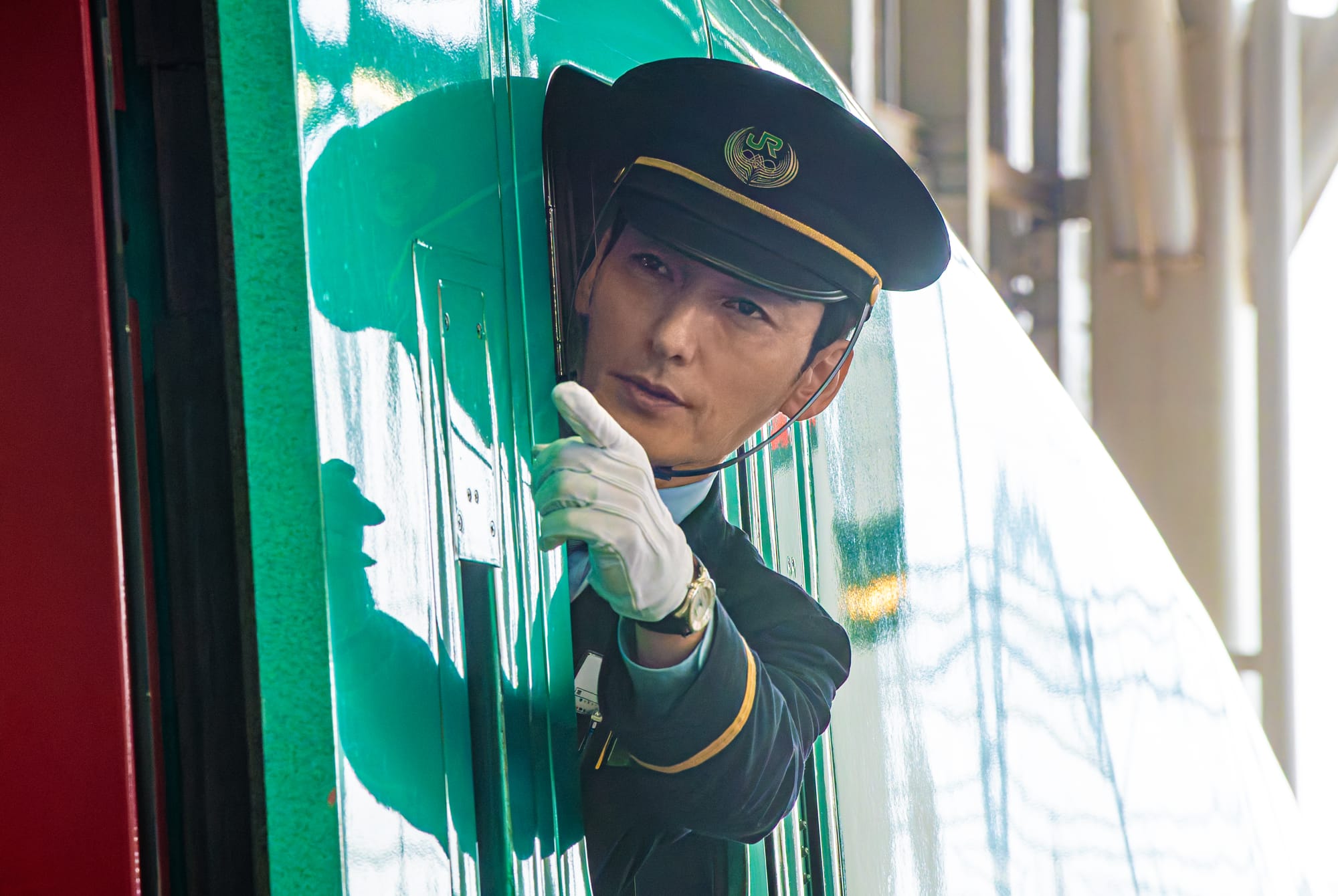 The conductor preparing for departure in Bullet Train Explosion