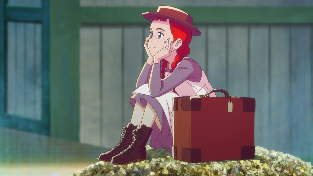 Anne Shirley from Anne of Green Gables sitting on a rock with a suitcase.
