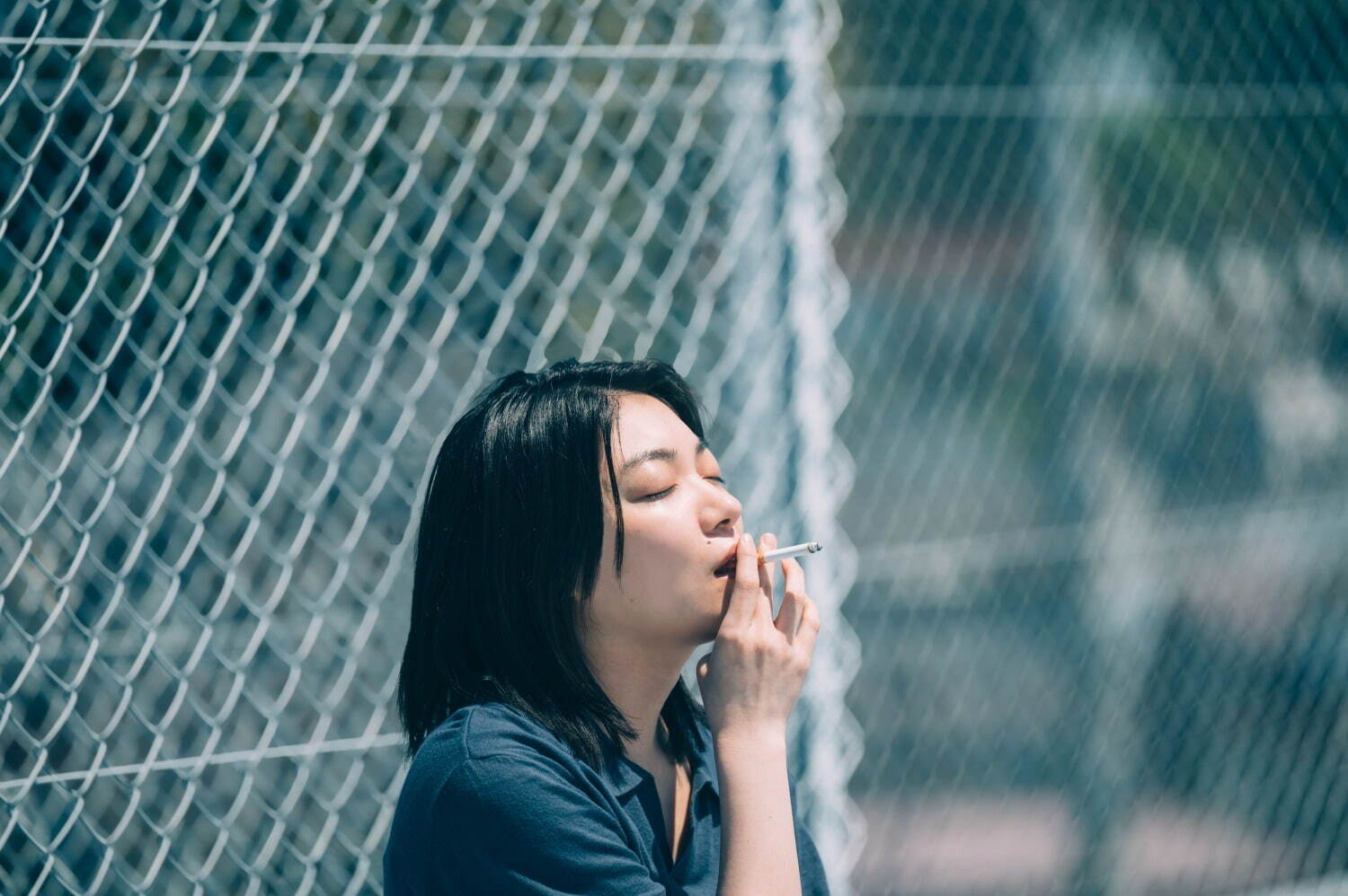 Kasumi smoking a cigarette in I Am What I Am