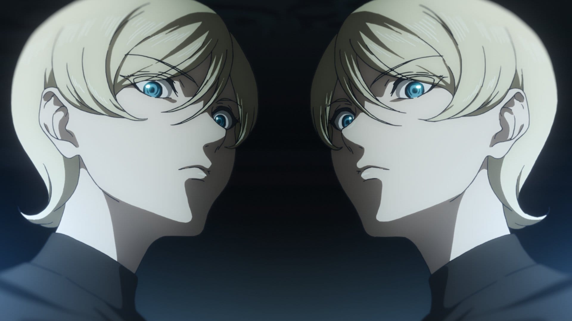 Migi & Dali twins standing beside each other and looking down.