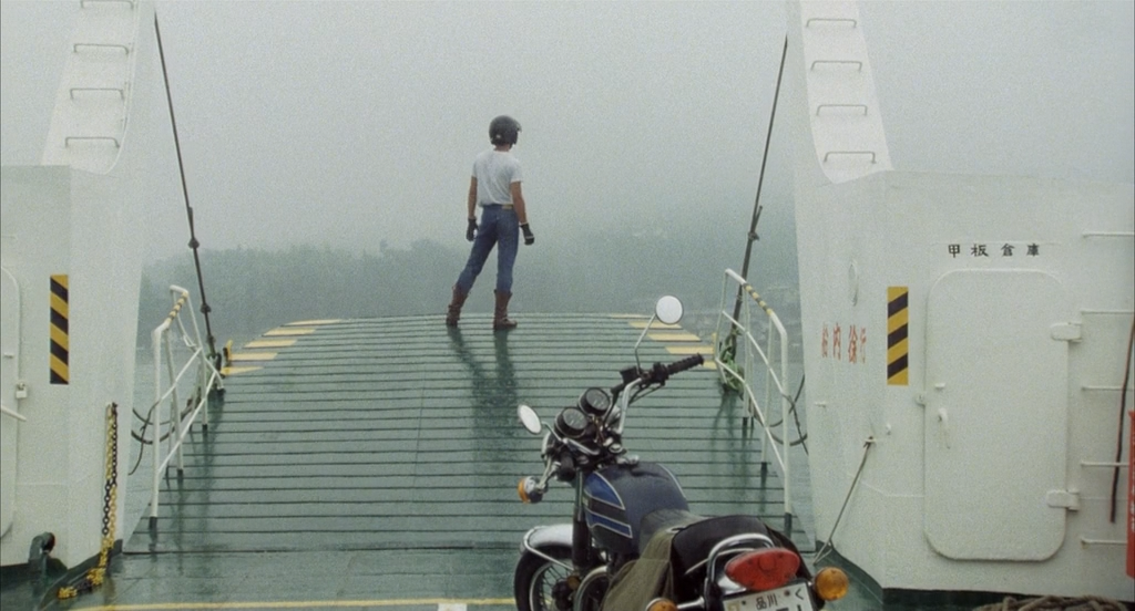 Ko looks out over a body of water in His Motorbike, Her Island