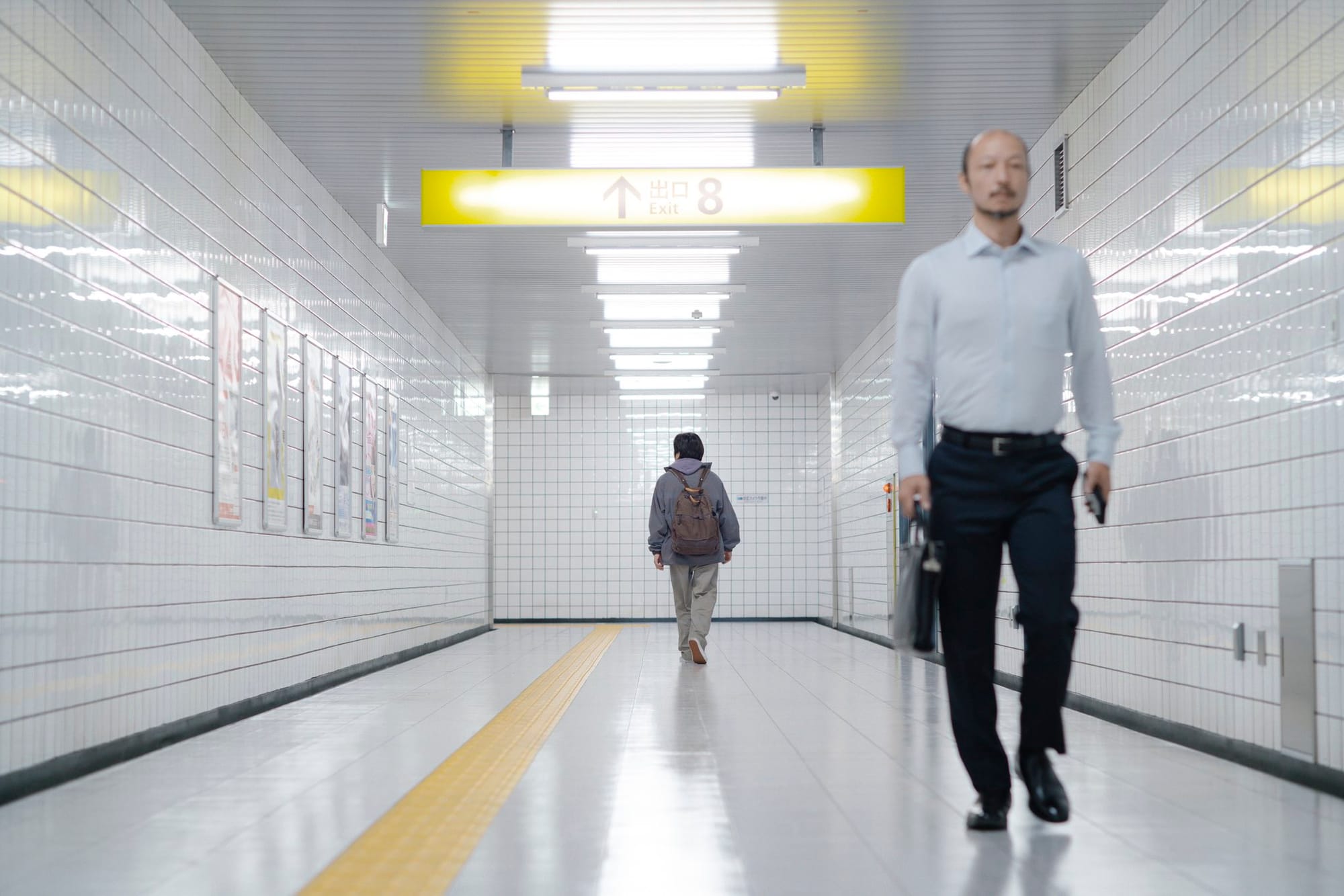 The lost man passes the walking man in Exit 8