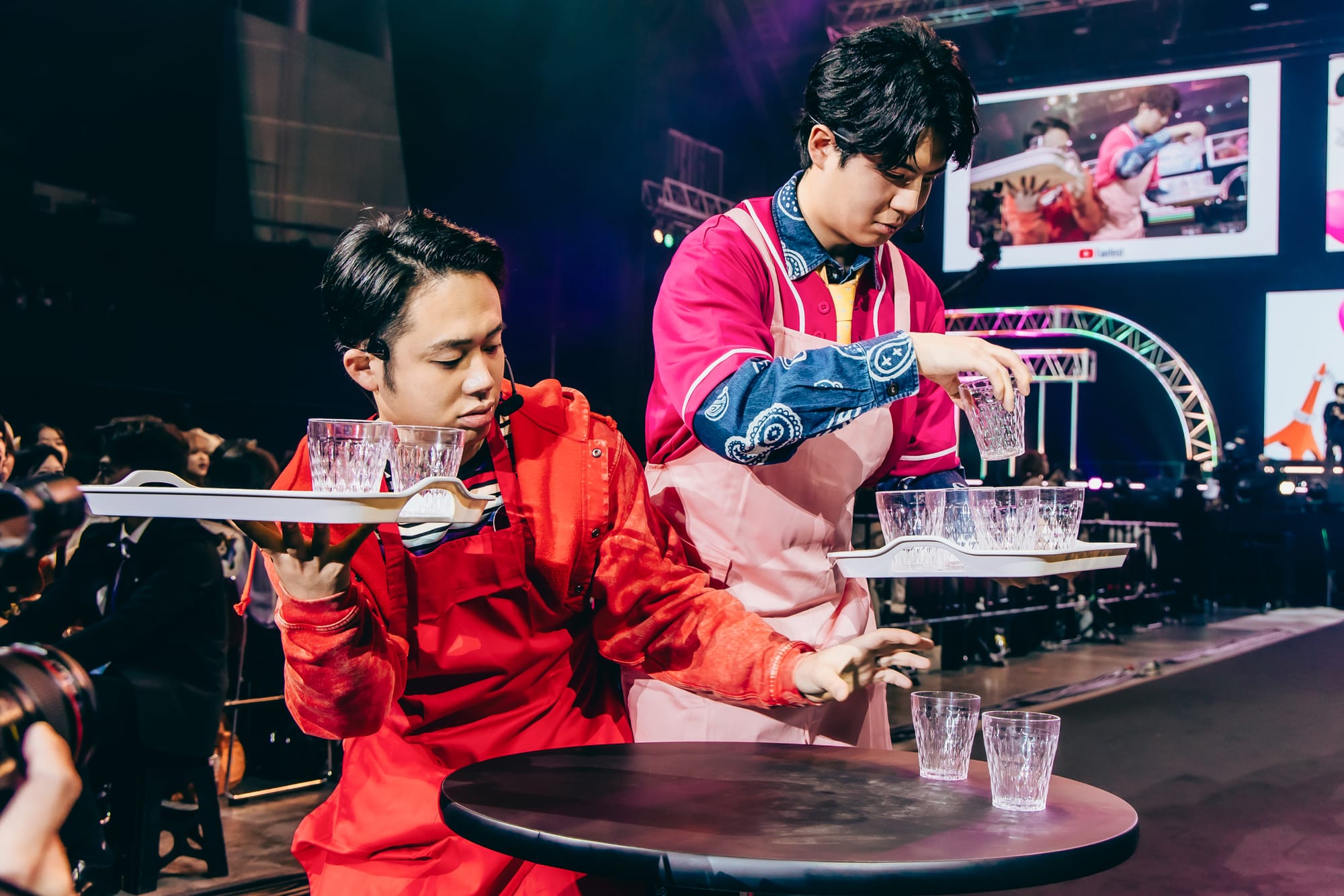 Fischer sees who can carry more glasses of water