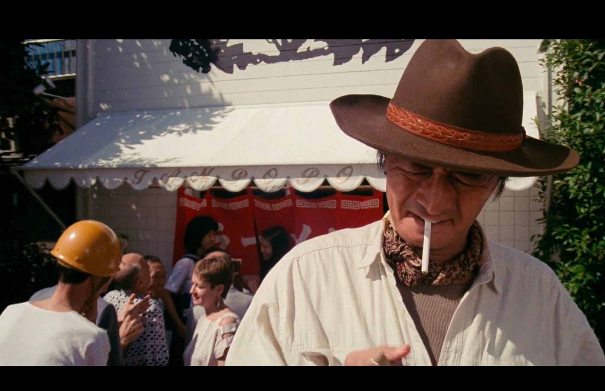 Goro trying to smoke in front of restaurant.