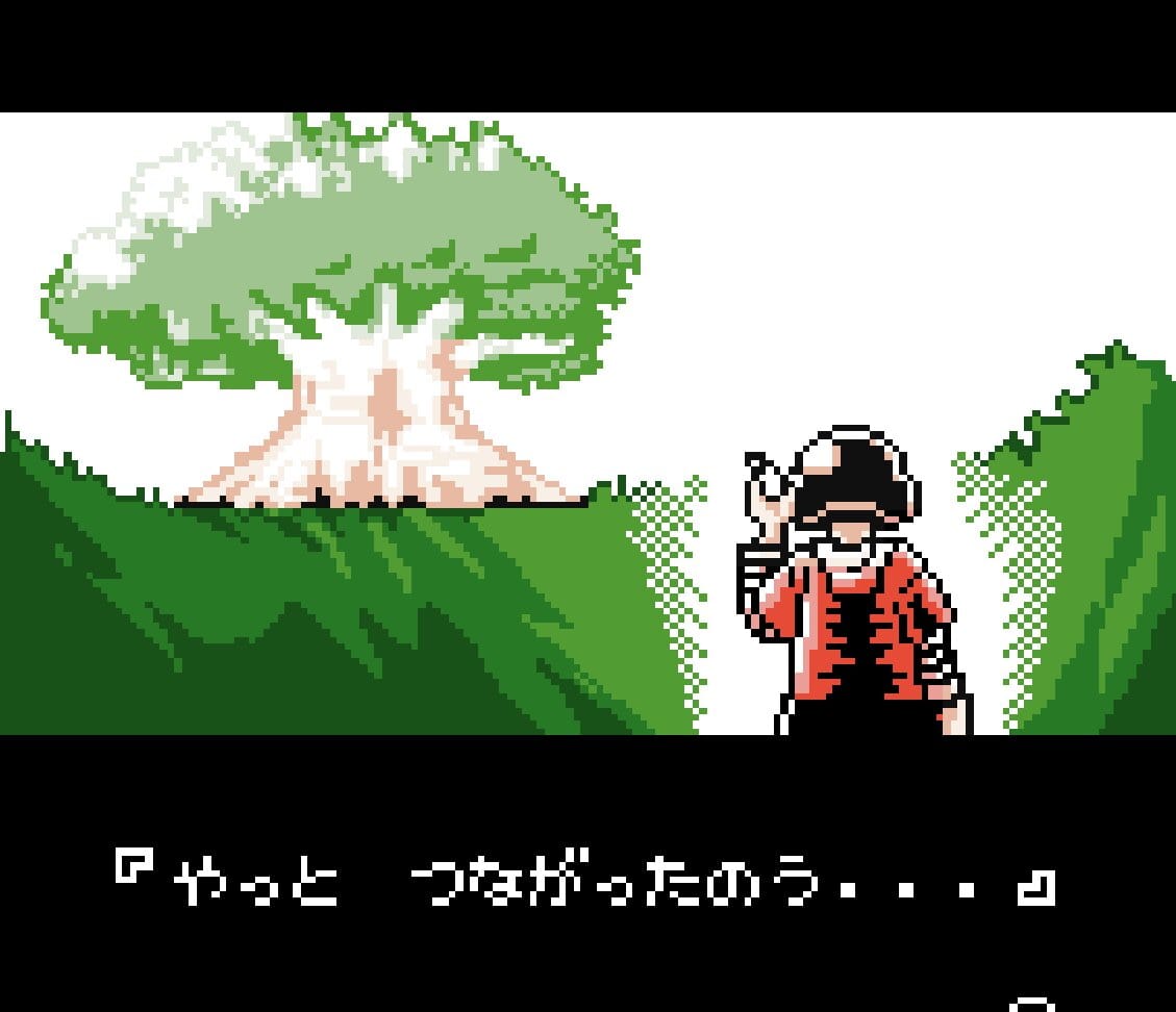 A boy wearing a baseball helmet picks up a message on his cellphone. A large tree can be seen in the distance.