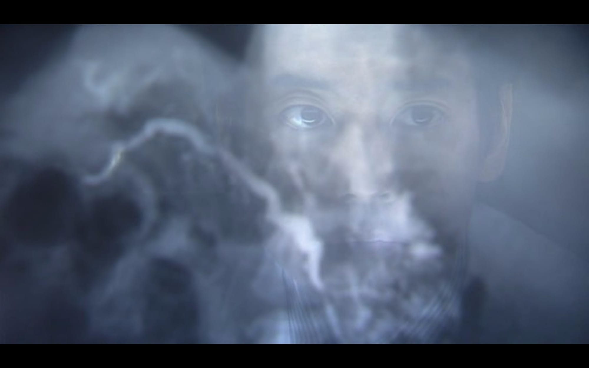 A man's face is reflected in the screen of an X-ray.