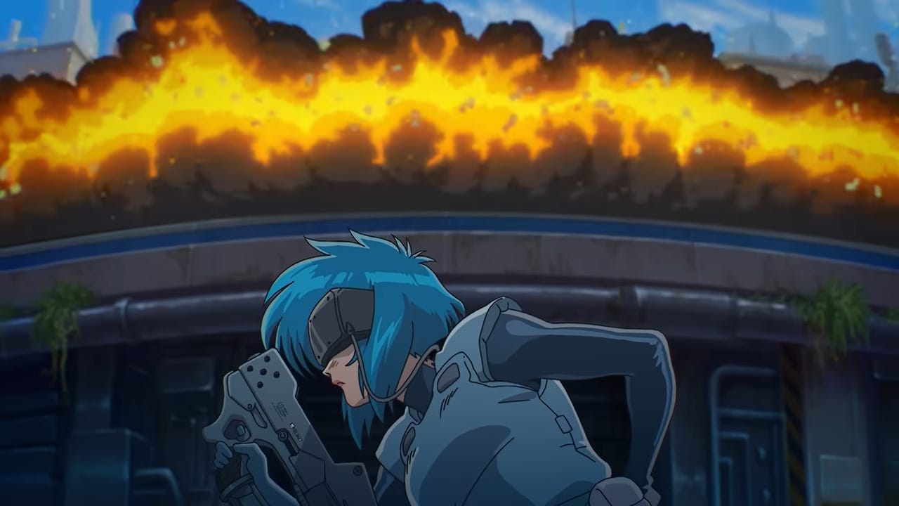 Motoko poses with a gun as the road explodes into flame behind her.