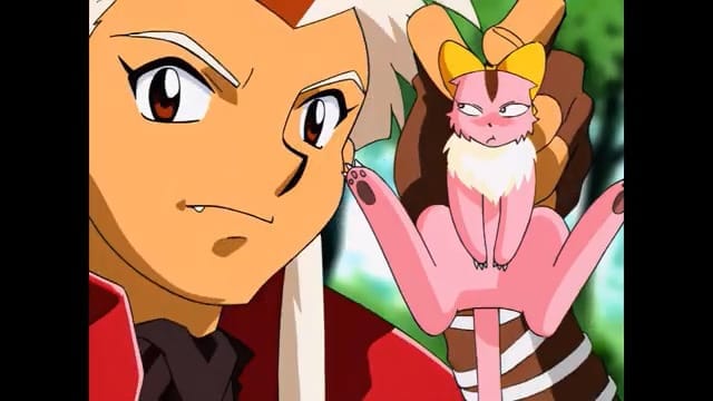 Nall, a dragon in human form with white hair, holds the pink baby cat-like dragon Ruby in his hand.