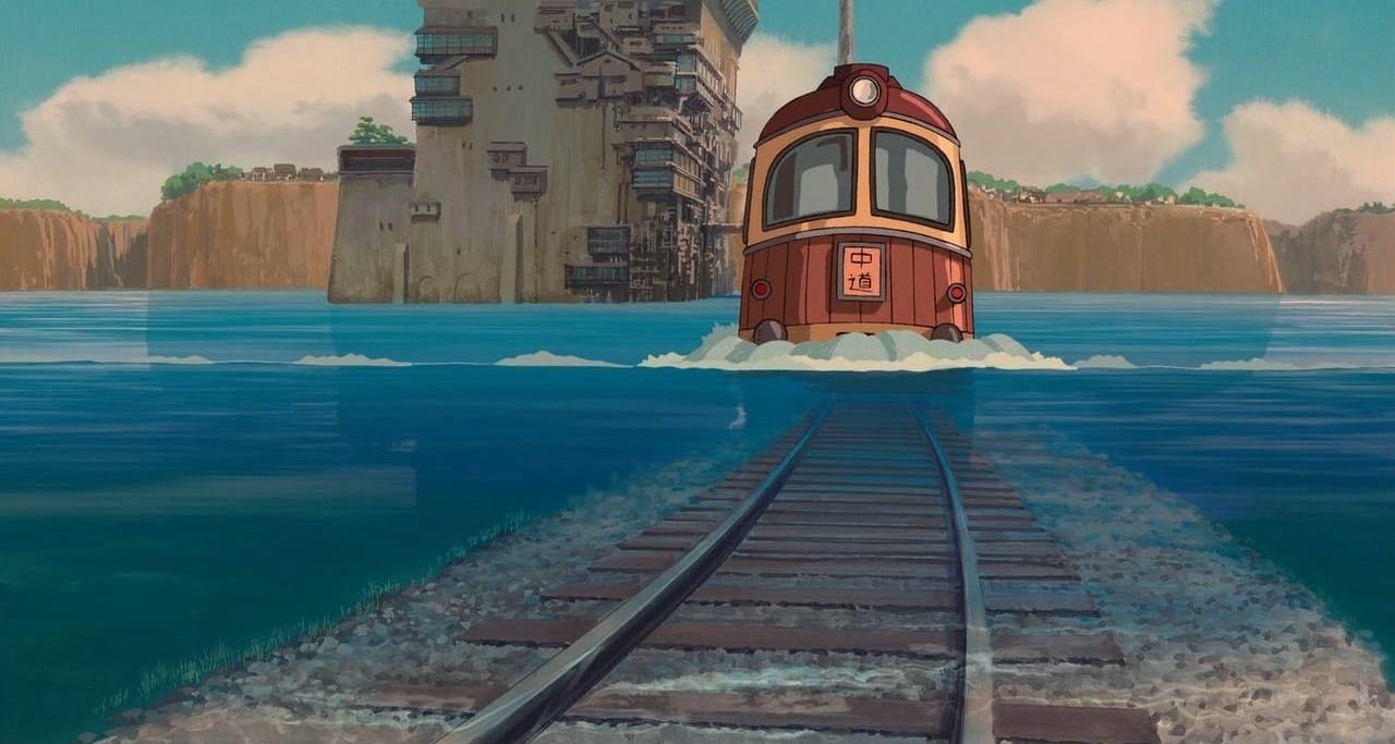spirited away brown train arriving on watery tracks.