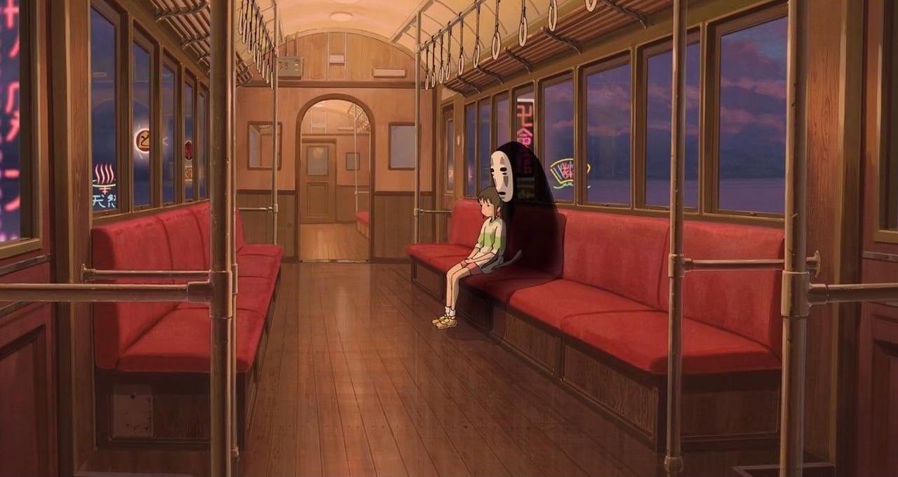 spirited away chihiro and no face sit alone on a train in the middle of the night